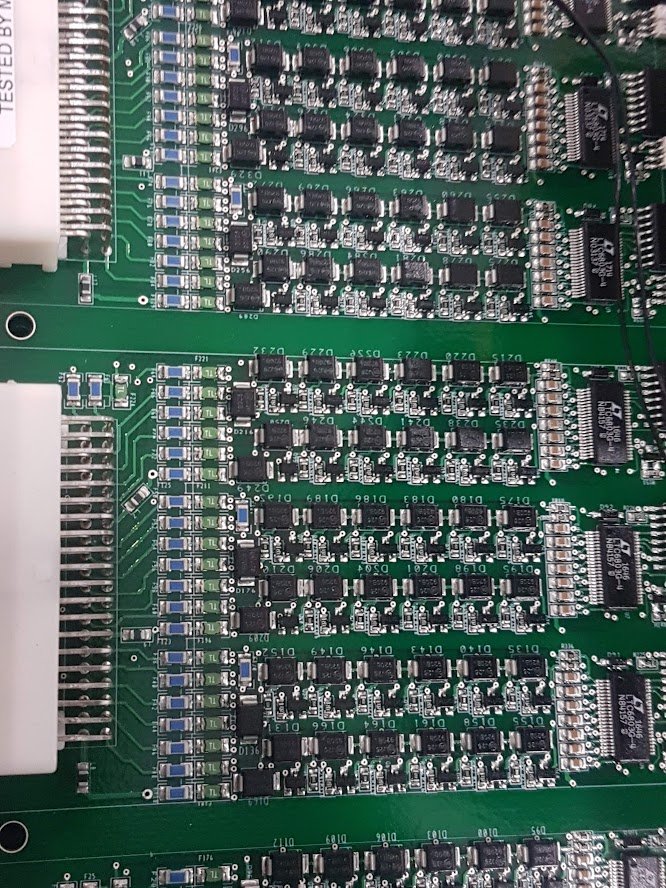 Assembled BMS boards with cell-monitor ICs and balancing banks — photograph, February 2019